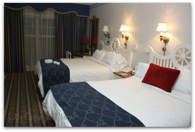 A bedroom with a large bed in a room, disney yacht club hotel