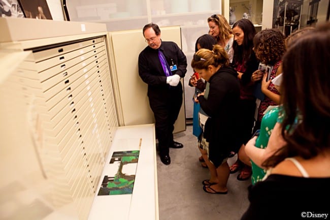 A group of people standing in a room, disney animation research library