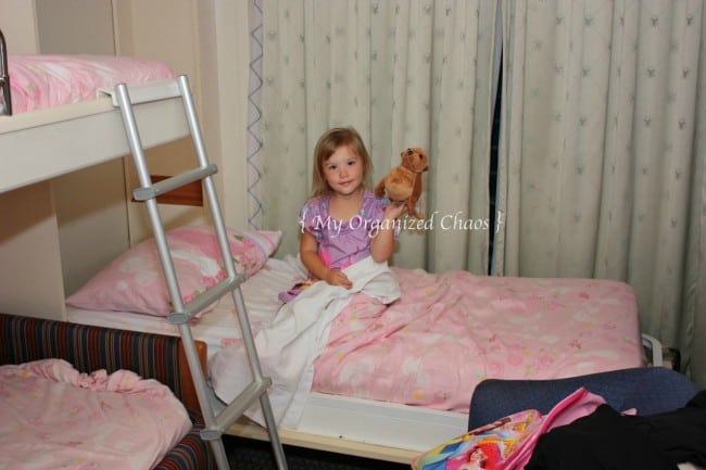 A little girl sitting on a cruise bed