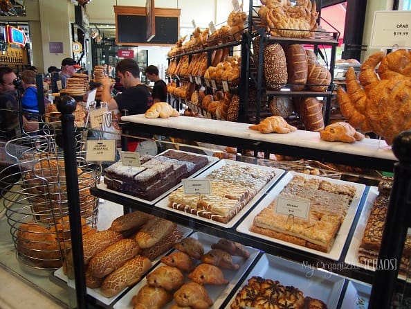 A display in a store filled with lots of food, with Bakery and Street