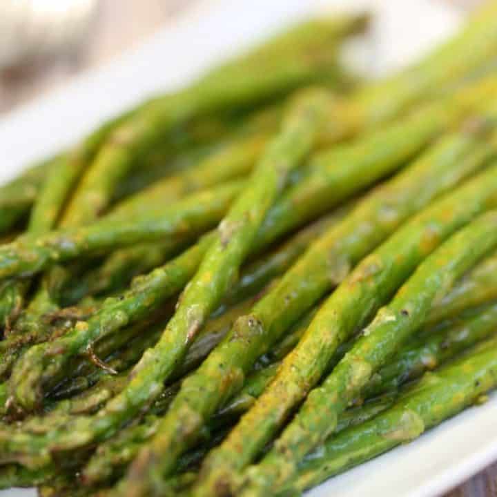 A close up of a plate of food, with Lemon pepper asparagus