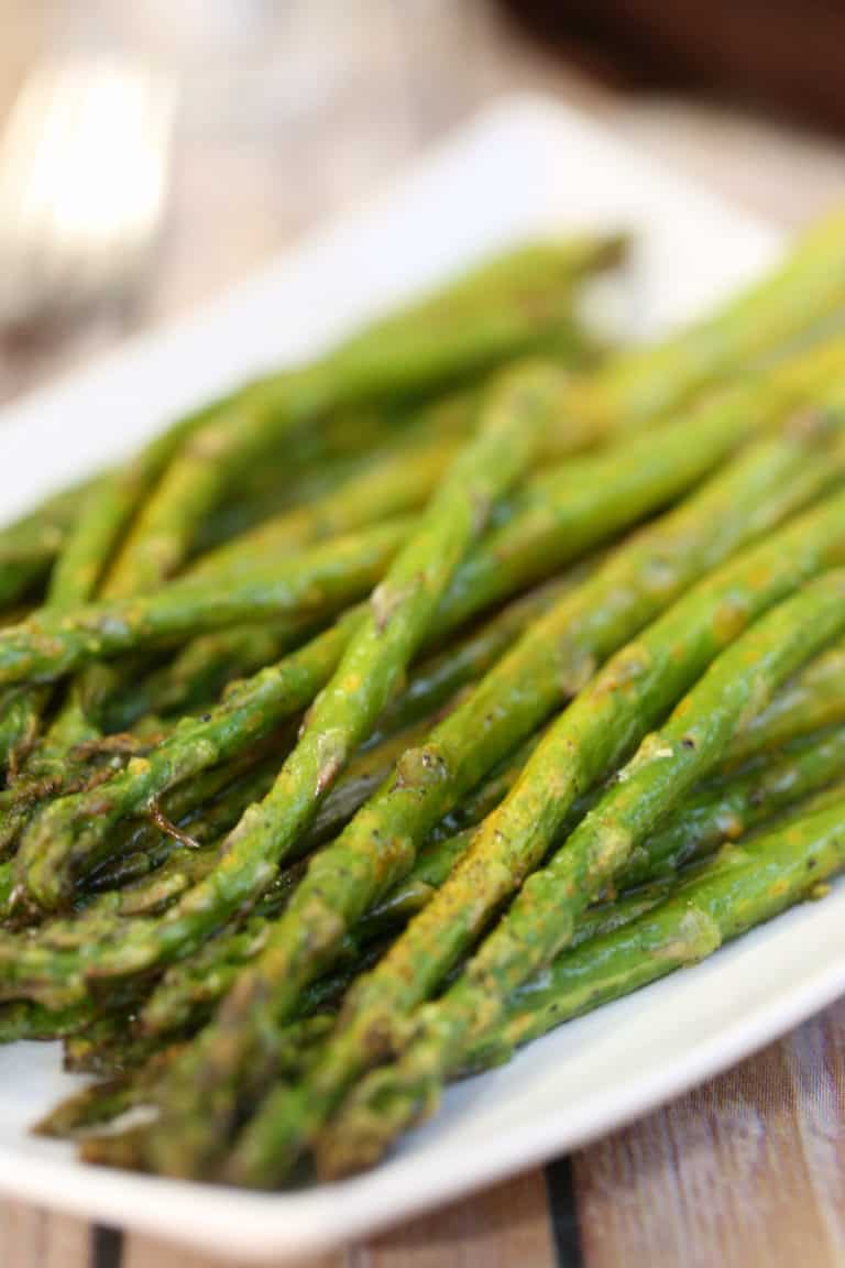 A close up of a plate of food, with Lemon pepper asparagus