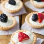 Mini Cream Cheese Fruit Tarts with fresh berries on top.