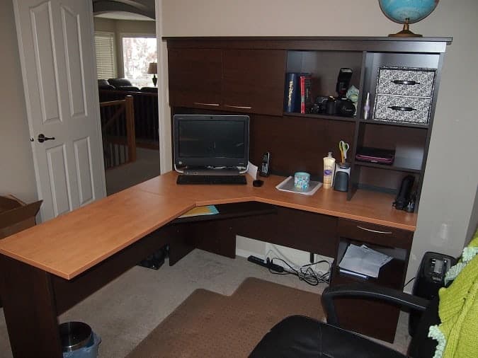 A desk with a laptop in a room