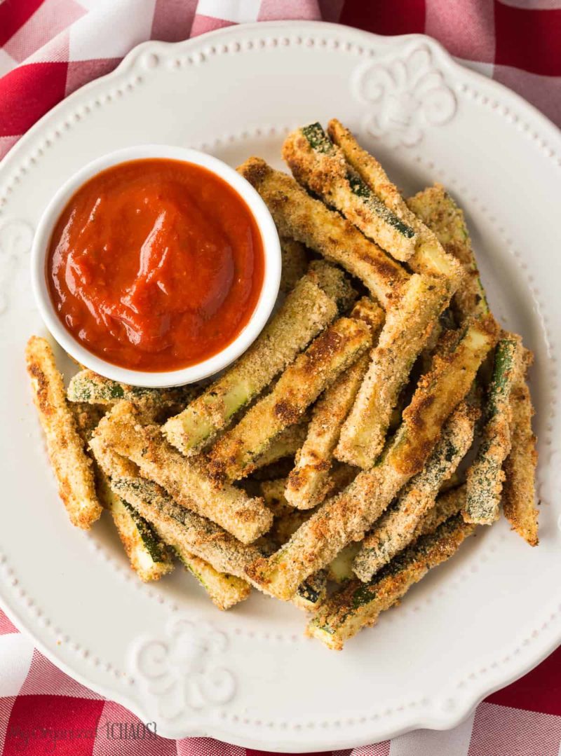 A plate of food on a table, with Baked zucchini fries