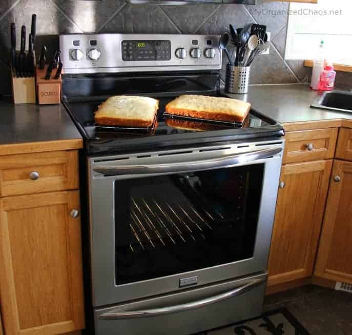 A stove top oven sitting inside of a kitchen with stainless steel appliances