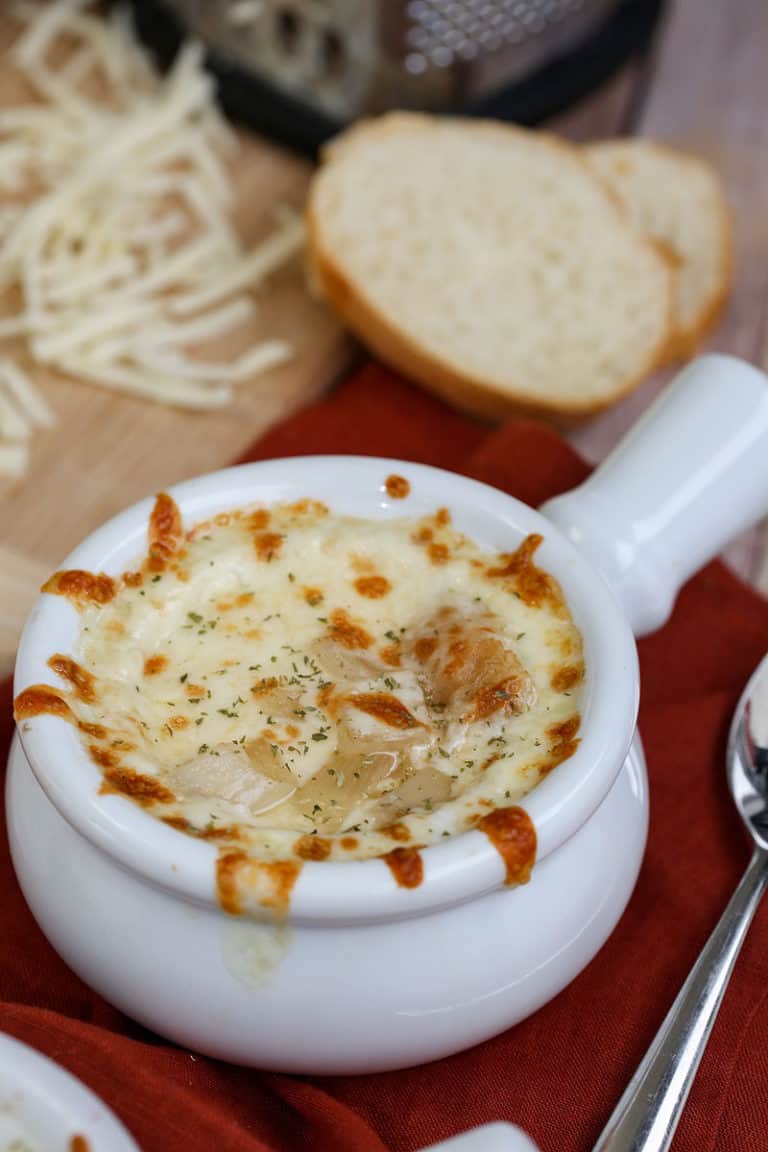 A plate of food on a table, with french onion soup