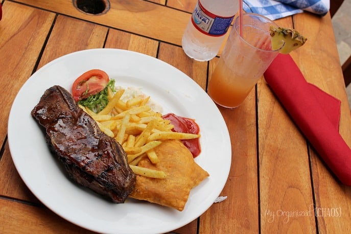 A plate of food sitting on top of a wooden table, at Beaches Negril