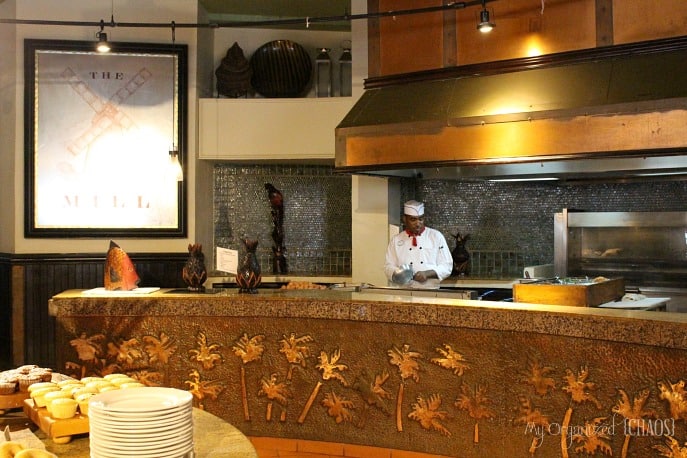 A person cooking food in a kitchen, with Buffet, at Beaches Negril