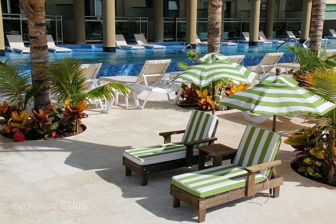 A pool and chairs at generations resort