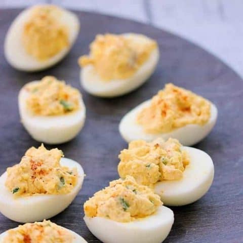 A plate of food on a table, with deviled eggs