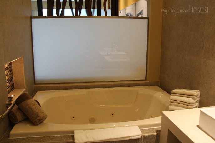 A large tub next to a sink at generations resort