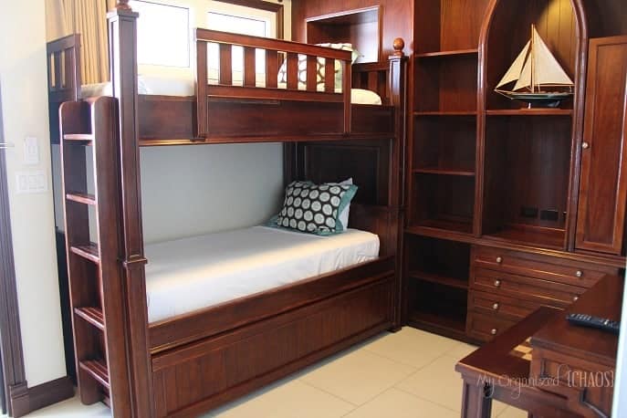 A bedroom with a bed and wooden furniture