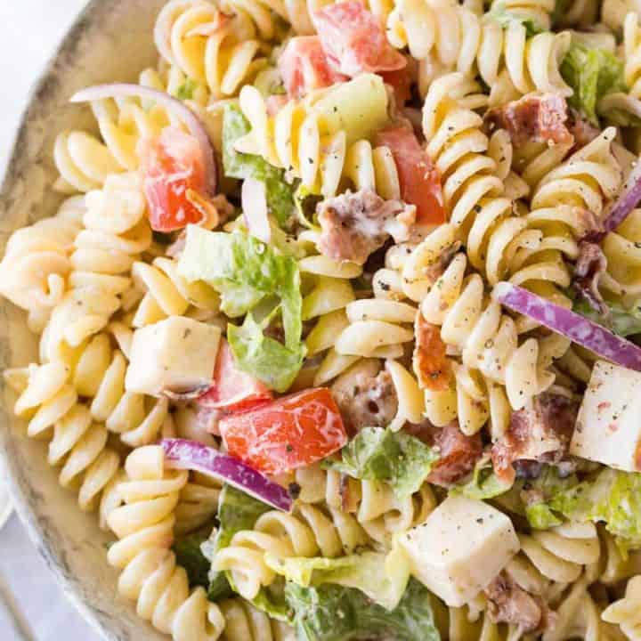 A dish is filled with pasta and salad, with BLT Pasta Salad