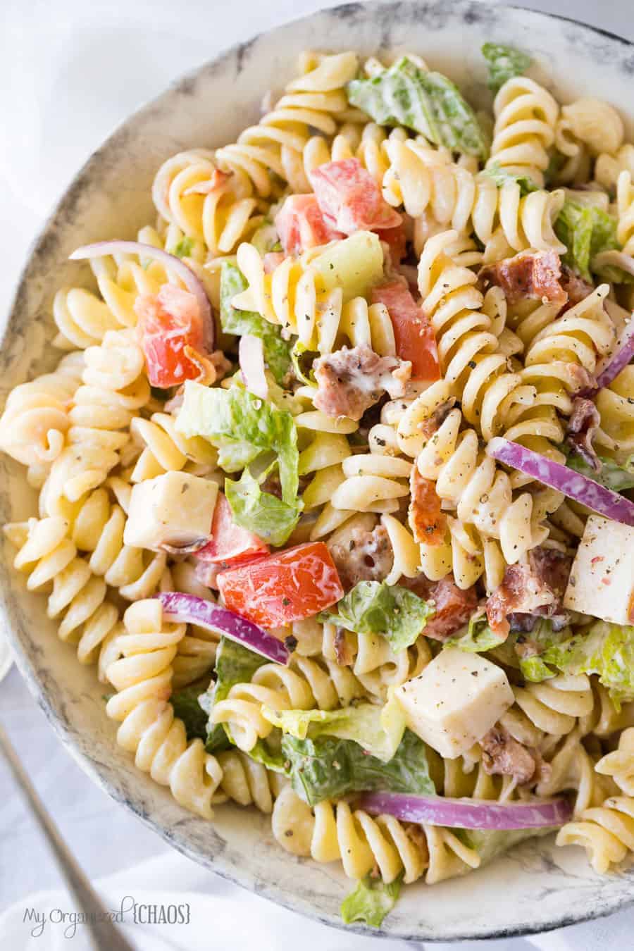 A dish is filled with pasta and salad, with BLT Pasta Salad