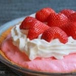 A cake with a dessert on a plate, with Pie and Strawberry