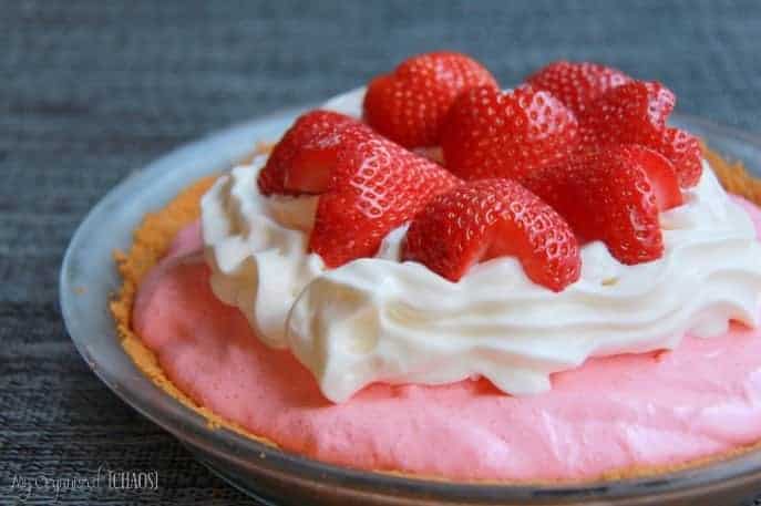 A cake with a dessert on a plate, with Pie and Strawberry