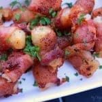 A close up of a plate of food, with Bacon and Tater tots