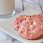 A close up of cookies on a plate, with pink Cookie