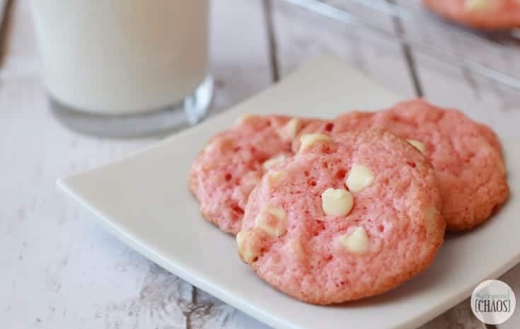A close up of cookies on a plate, with pink Cookie
