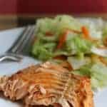 A close up of a plate of food with a fork, with Salmon