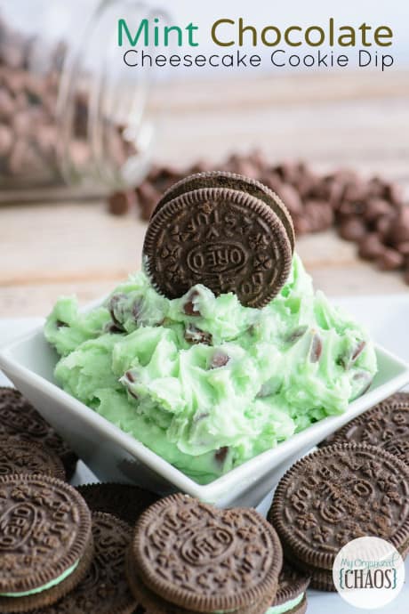 green dessert dip with chocolate dips in a bowl with a whole oreo cookie placed on top.
