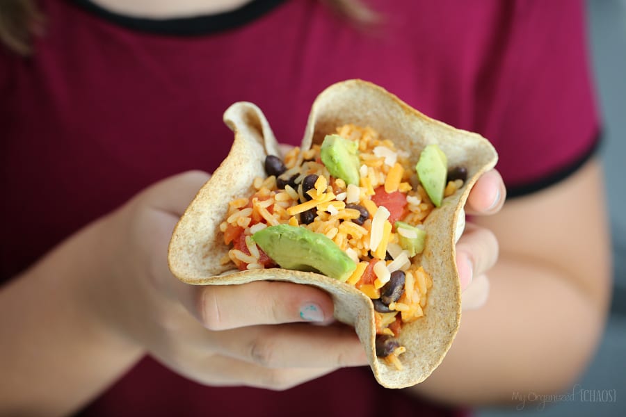 A close up of a person holding a taco in his hand