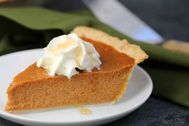 A close up of a slice of pie on a plate, with Pumpkin pie