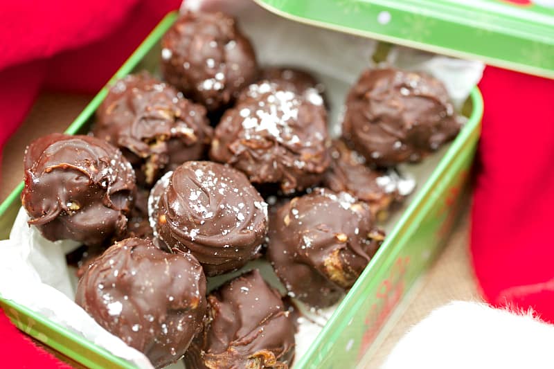 A container of food, with Peanut Butter Snowballs covered in Chocolate