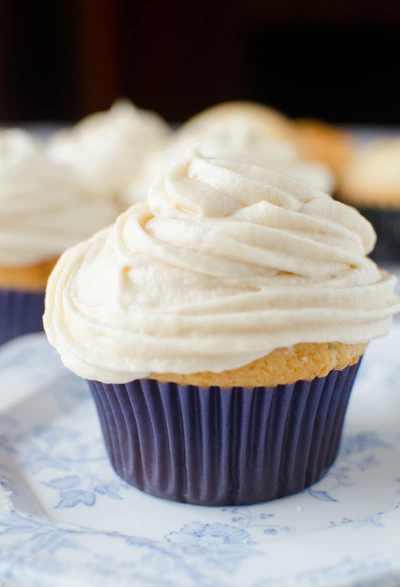 A close up of a cupcake on a plate, with Eggnog Cupcakes