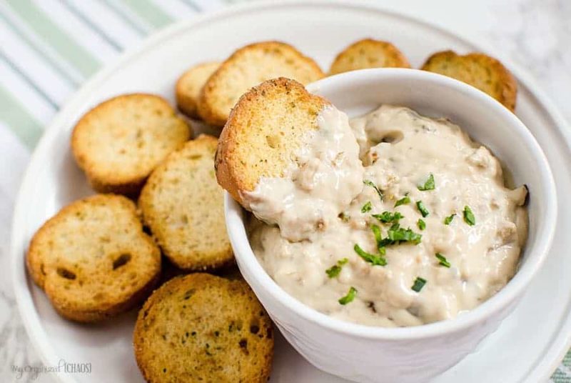 A bowl of food on a plate, with Mushroom dip and Slow Cooker
