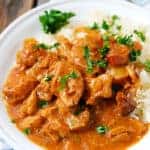 A plate of food with rice meat and vegetables, with Pork and Slow Cooker