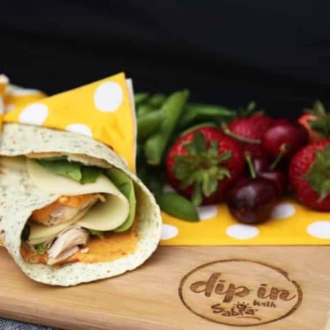 Roasted Red Pepper Turkey Wraps uses turkey, fresh spinach, basil, tasty provolone cheese, and Sabra Roasted Red Pepper Hummus for the spread. YUM!