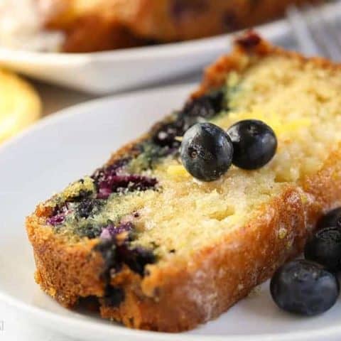 A close up of food on a plate, with Blueberry and Cake