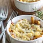 A bowl of food on a plate, with Cheese and Poutine