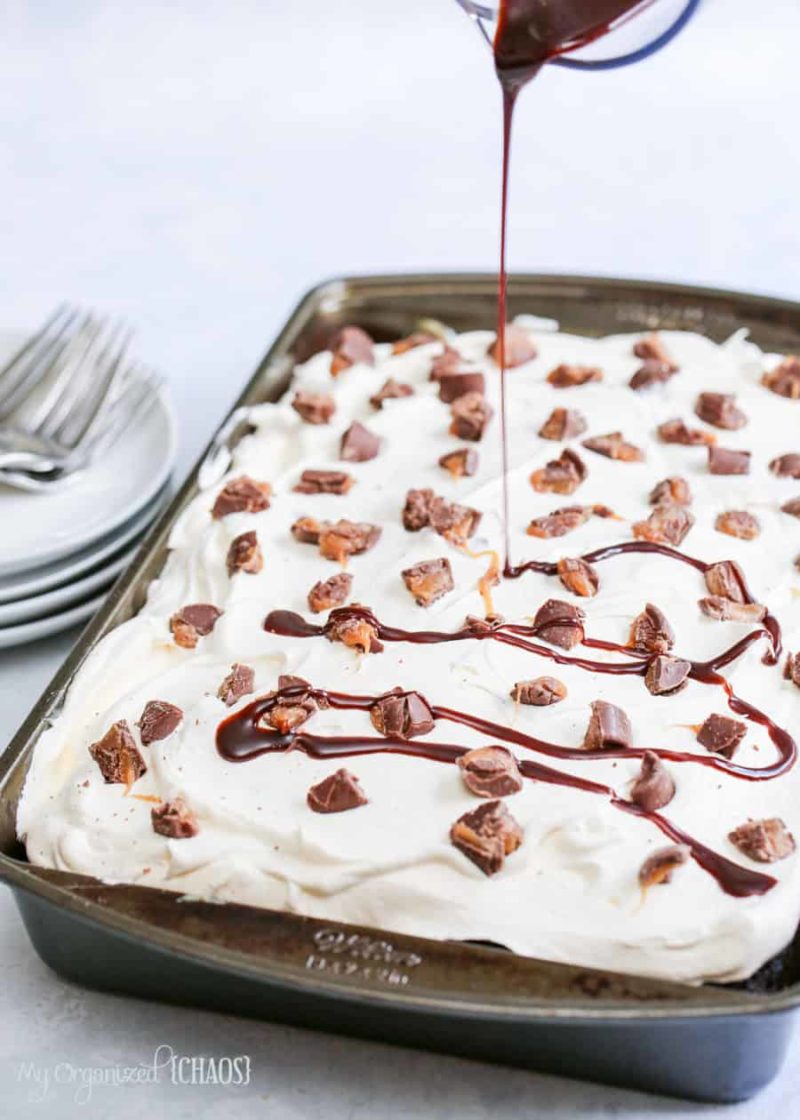 This Rolo Poke Cake is a delicious chocolate and carmel taste explosion with caramel sauce and a chocolate drizzle.