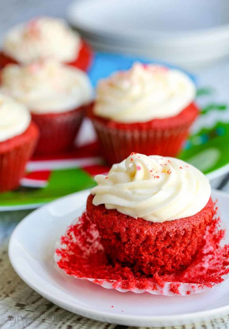 A close up of a slice of cake on a plate, with red velvet cupcakes