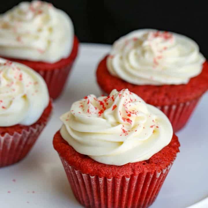 A close up of a slice of cupcakes on a plate, with red velvet cupcakes