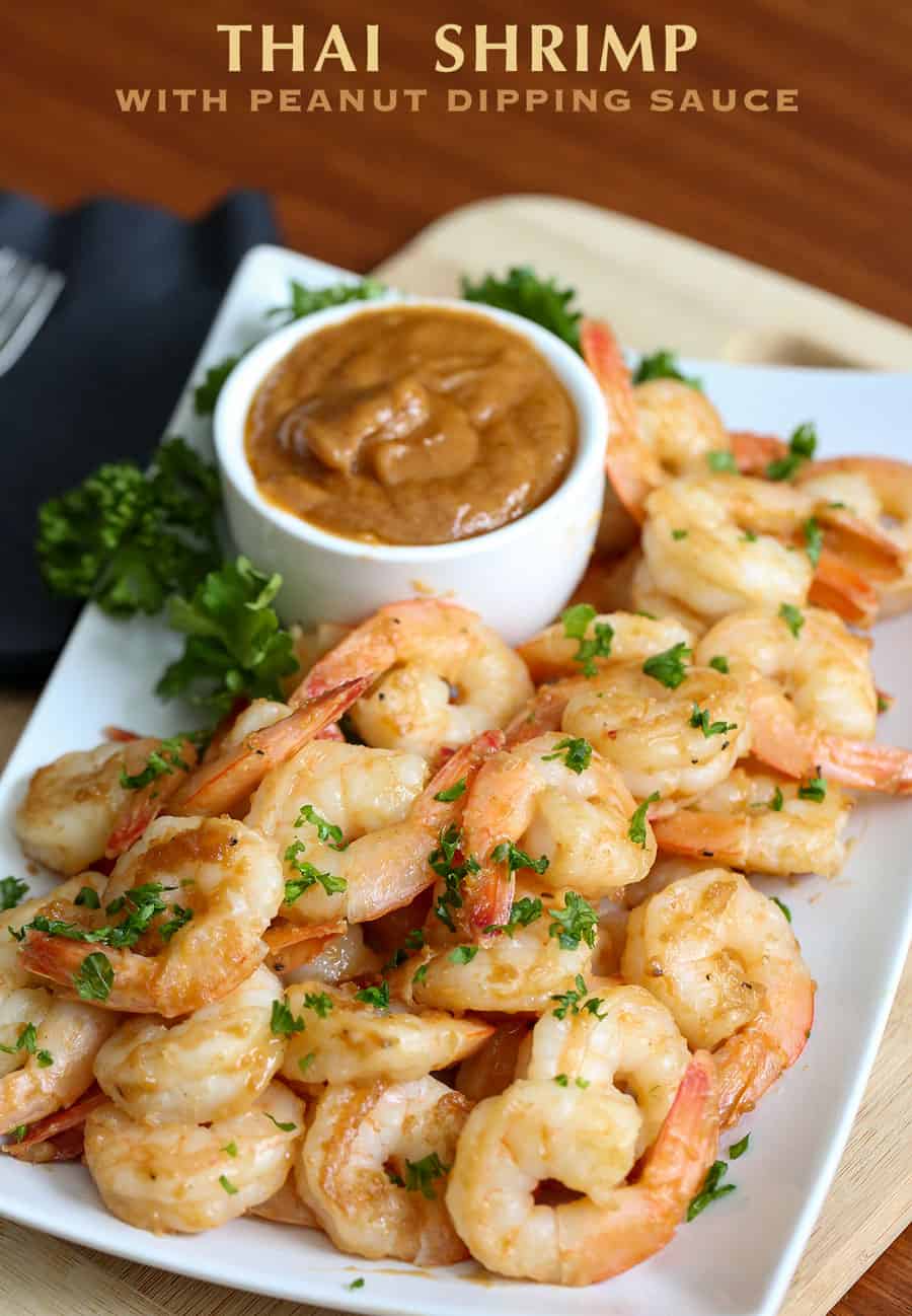 A plate of food on a table, with Shrimp and Sauce