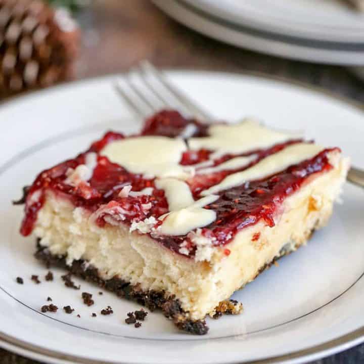 White Chocolate Raspberry Cheesecake Bars are sweet and tangy. The combination of an Oreo crust, white chocolate and raspberry jam is perfection