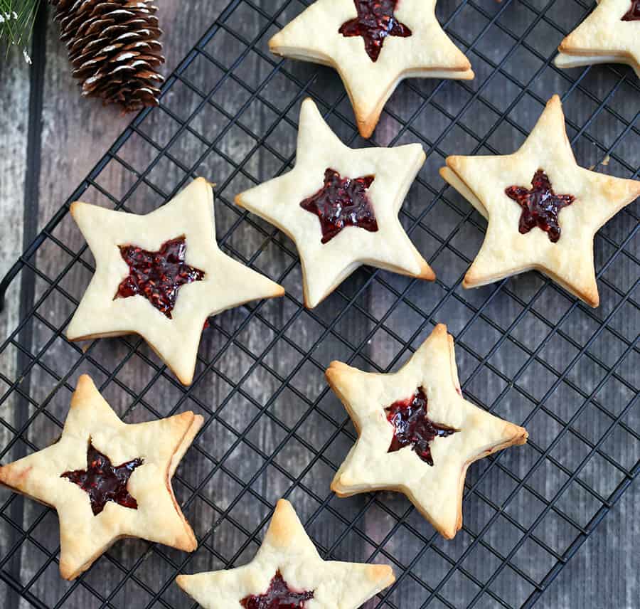 You can be the of the holiday party or baking exchange with these Star-Shaped Jam Cookies. They are so festive, fun and elegant to make as a holiday treat.