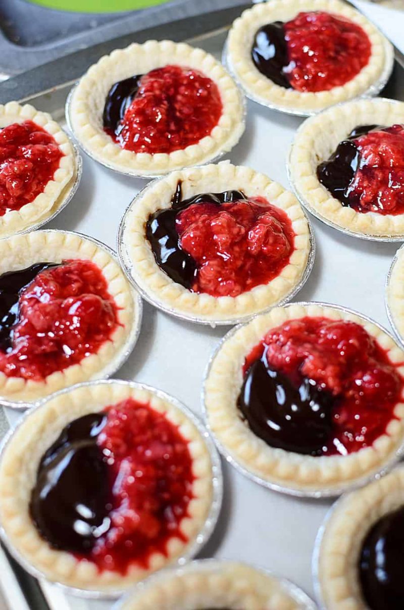 Chocolate Raspberry Tarts are as simple and easy recipe that is full-bodied in flavour. This quick tart dessert combines the creaminess of chocolate with the tang of a raspberry sauce. 