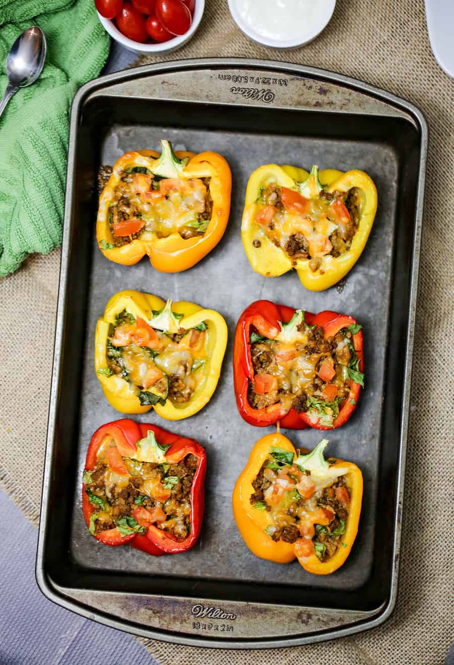 food on a tray, with Taco and Stuffed peppers