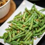 A plate of food on a table, with Green bean