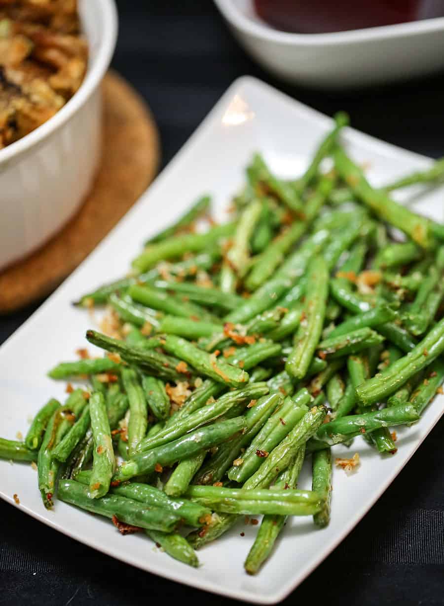 A plate of food on a table, with Green bean