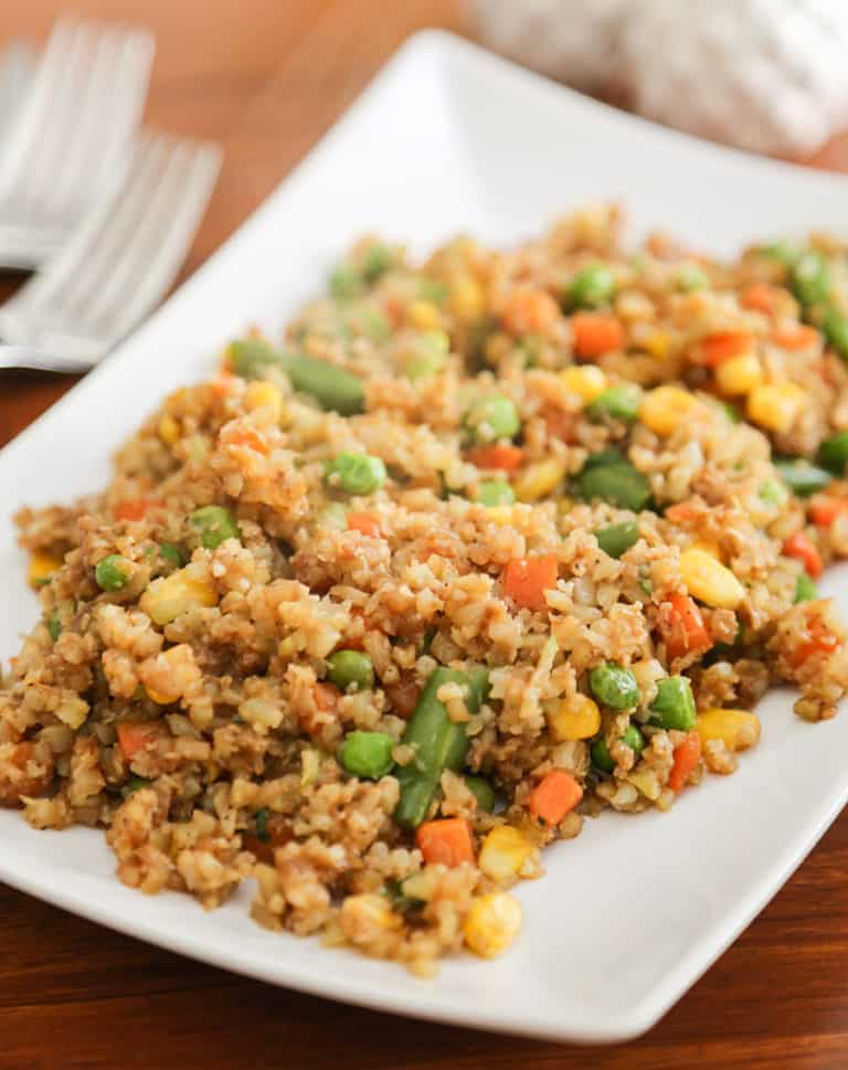 A plate of food on a table, with Rice and Cauliflower