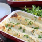 A dish is filled with food, with Chicken and Enchilada