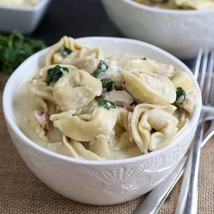 Instant Pot Tortellini Alfredo is a rich and delicious pasta recipe with bacon, chicken, spinach and a homemade Alfredo sauce. Kid-friendly and wonderful to use as leftovers, this dish is made in one pot which cuts down on prep and cook time, and makes cleanup a breeze!