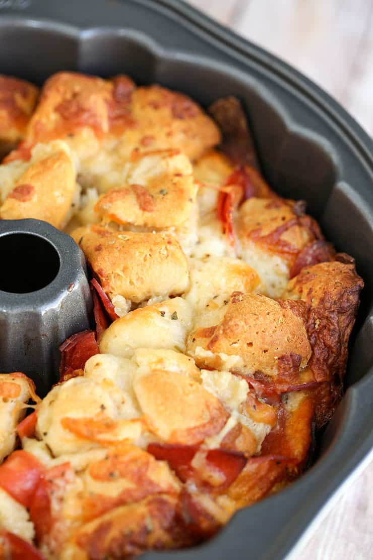 This easy Pizza Monkey Bread is stuffed with pepperoni, mozzarella cheese, and garlic all in a Bundt pan. If you love pizza, you'll love this pull-apart pizza made with refrigerated crescent rolls.