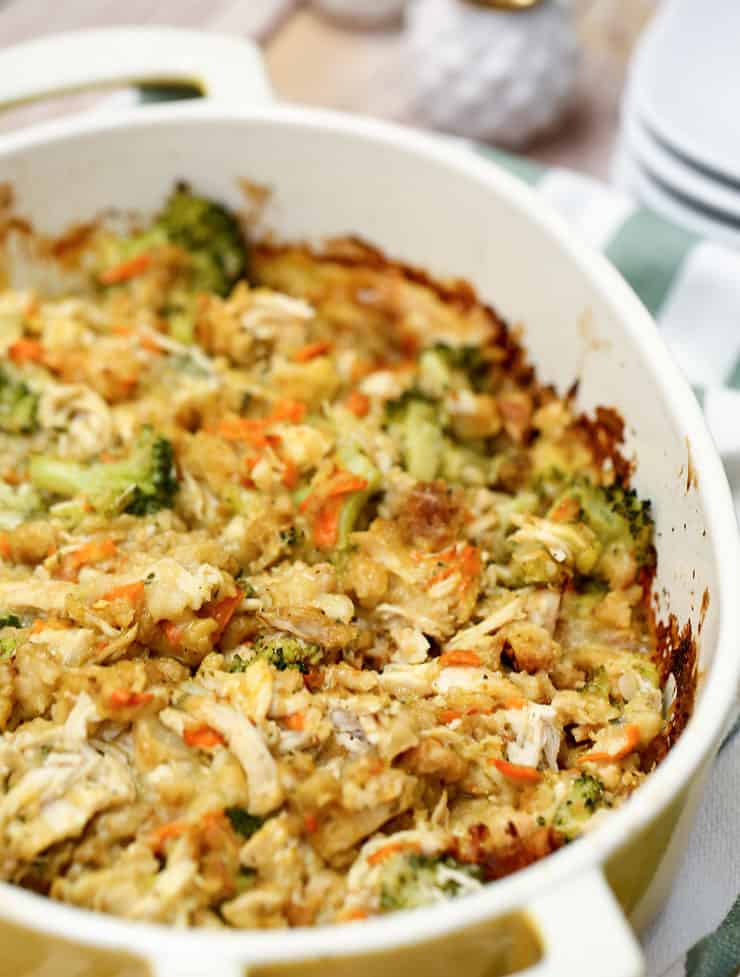 A bowl of food on a plate, with Chicken and Casserole